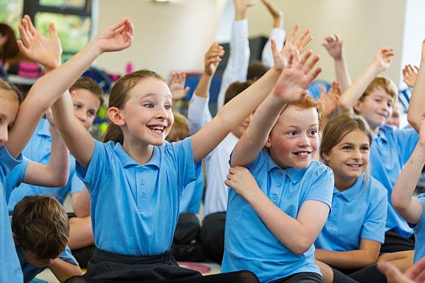 Pupils with hands up